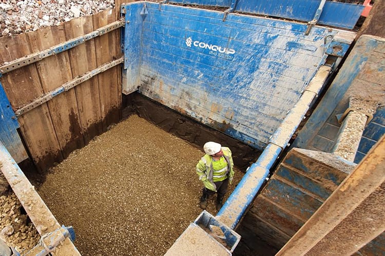 man in Conquip shoring box