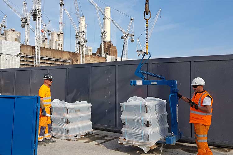 crane pallet forks attachment lifting a pallet of bricks